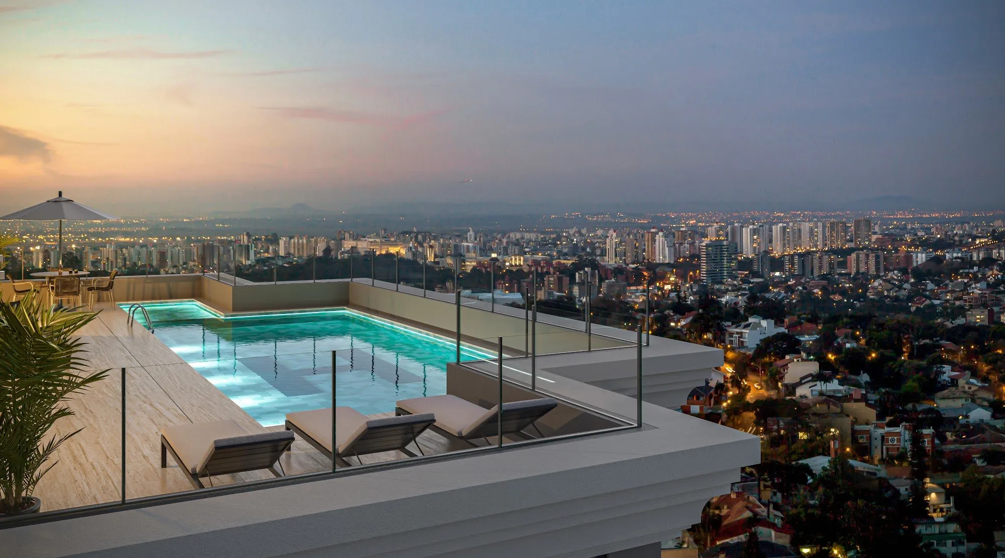 Piscina descoberta no alto do Harmonic Vila Ema, com vista da cidade ao entardecer