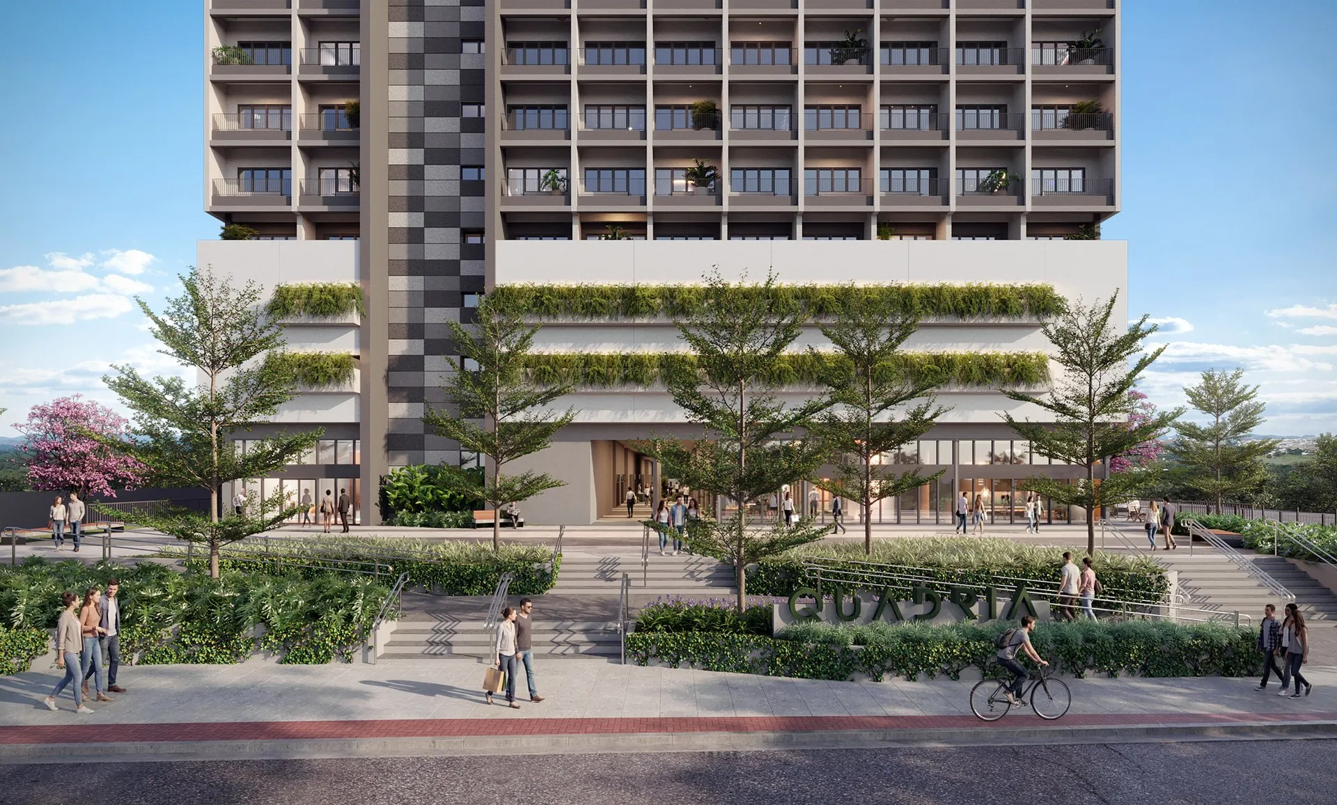 Fachada do Quadria Vista Verde vista da rua, com o mall no térreo, árvores e jardins na calçada