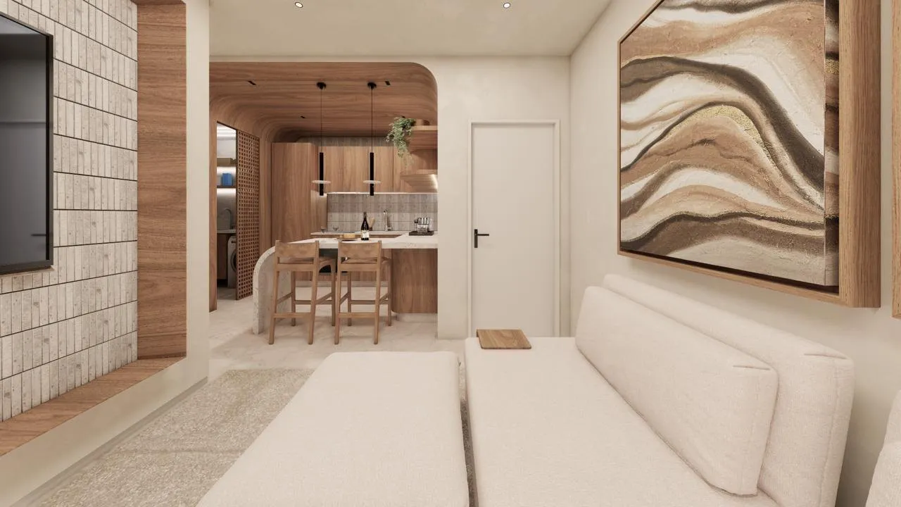 Sala do apartamento de 1 dormitório do Úniko Vila Ema, com sofá e a cozinha ao fundo